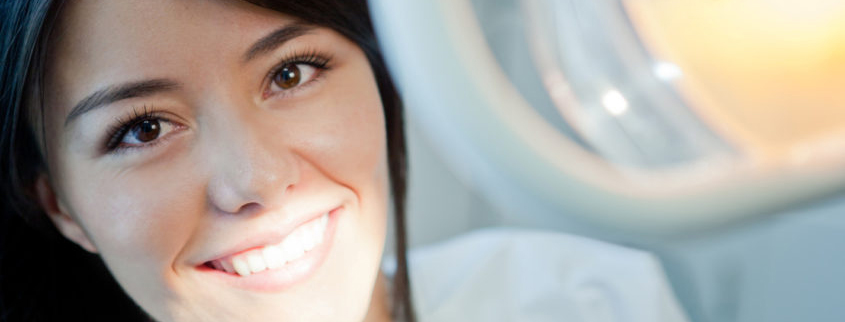 Young woman portrait visiting the dentist and smiling